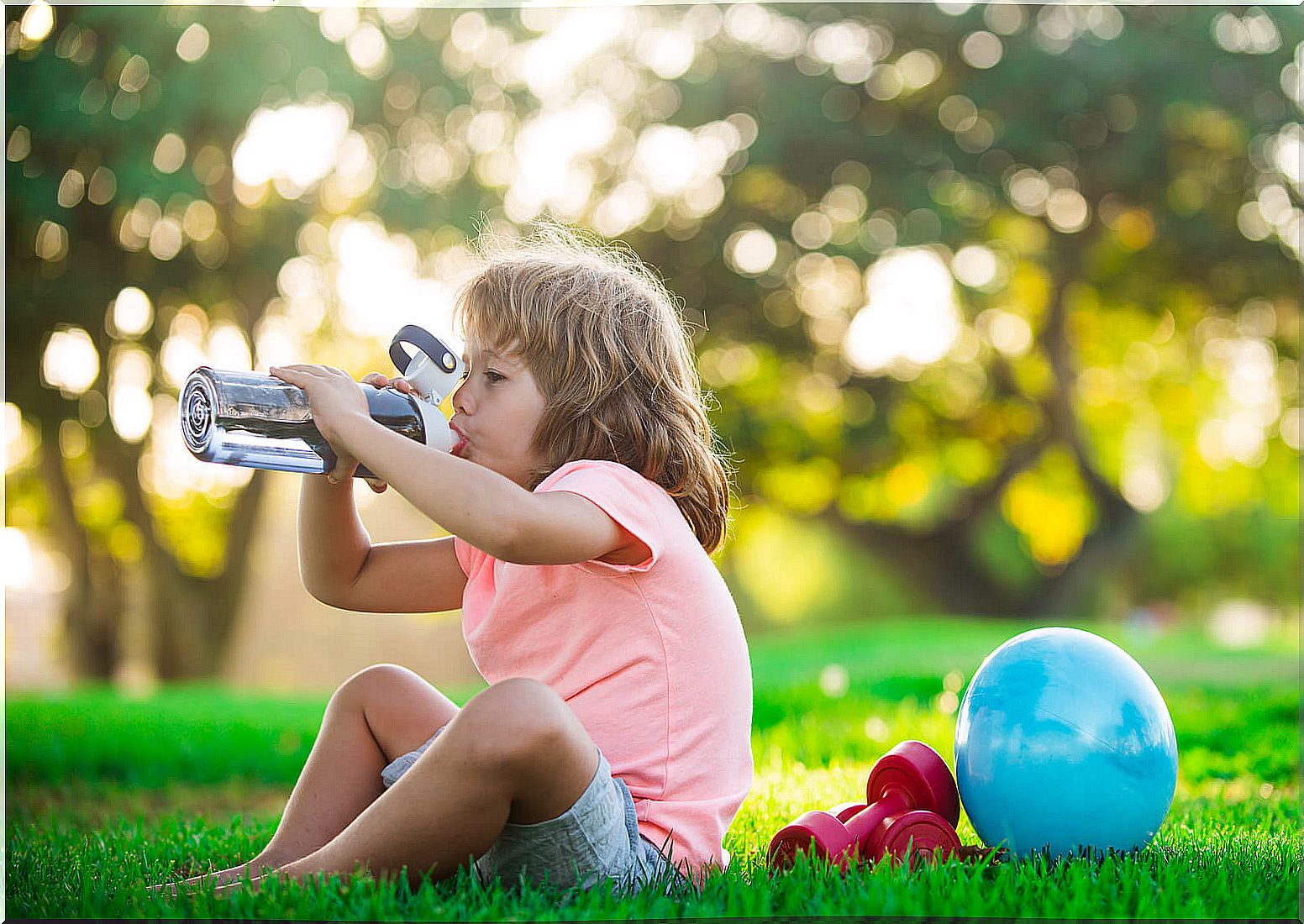 Girl drinking water after playing sports.