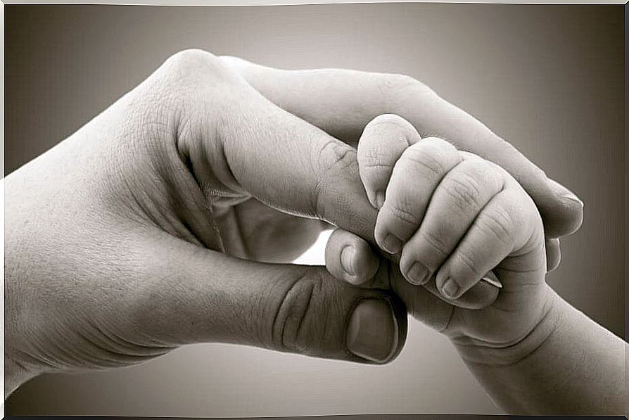 Hand of a mother with her baby