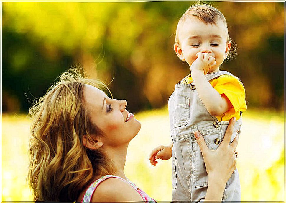 Mother talking with her son and doing some exercises to stimulate language in children 1 to 2 years old.