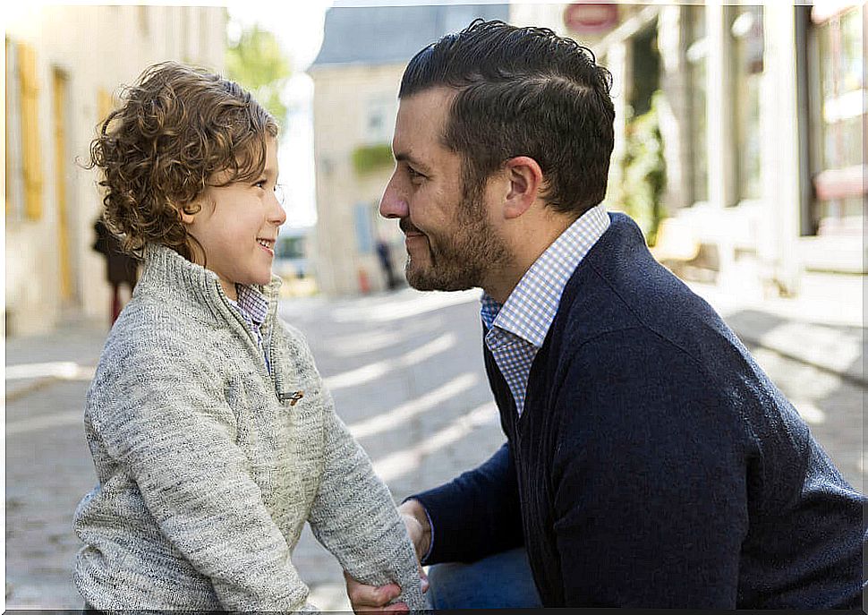 Father talking to his son on the street.