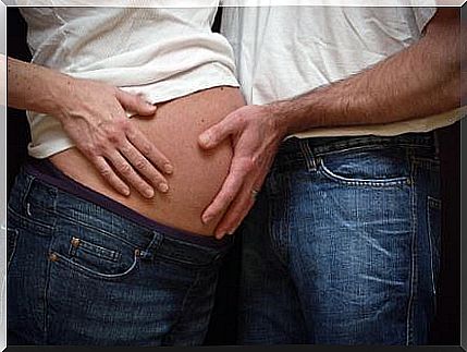 Father touching mom's pregnant belly