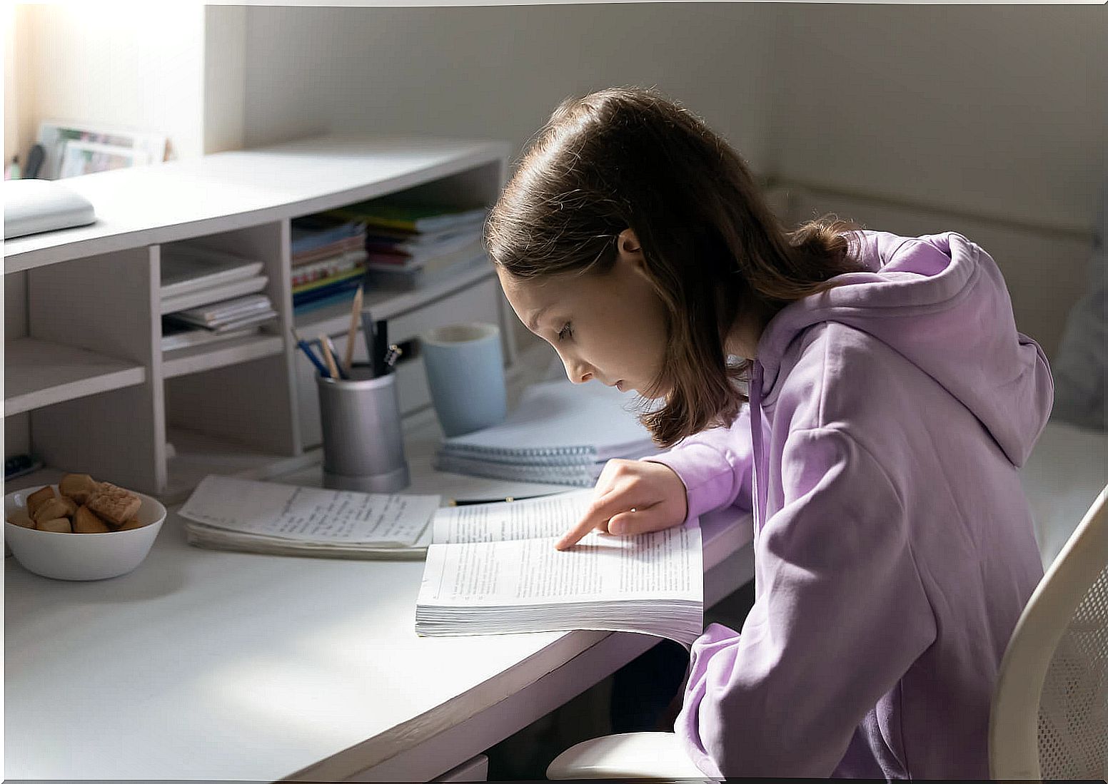 Teen girl in her room studying.