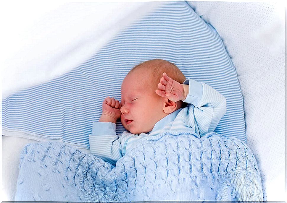 Newborn baby asleep in his crib.