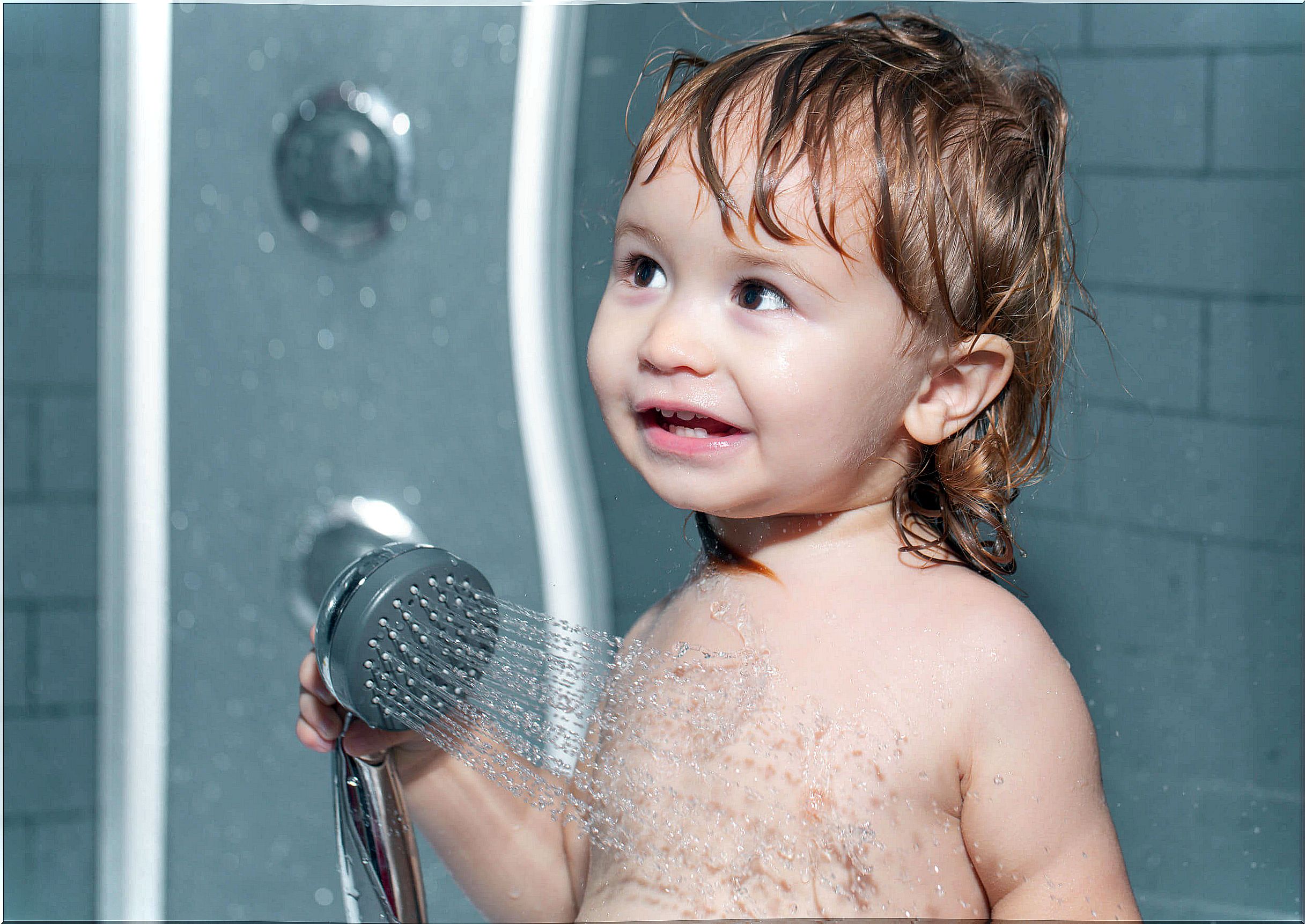 Child taking a shower.