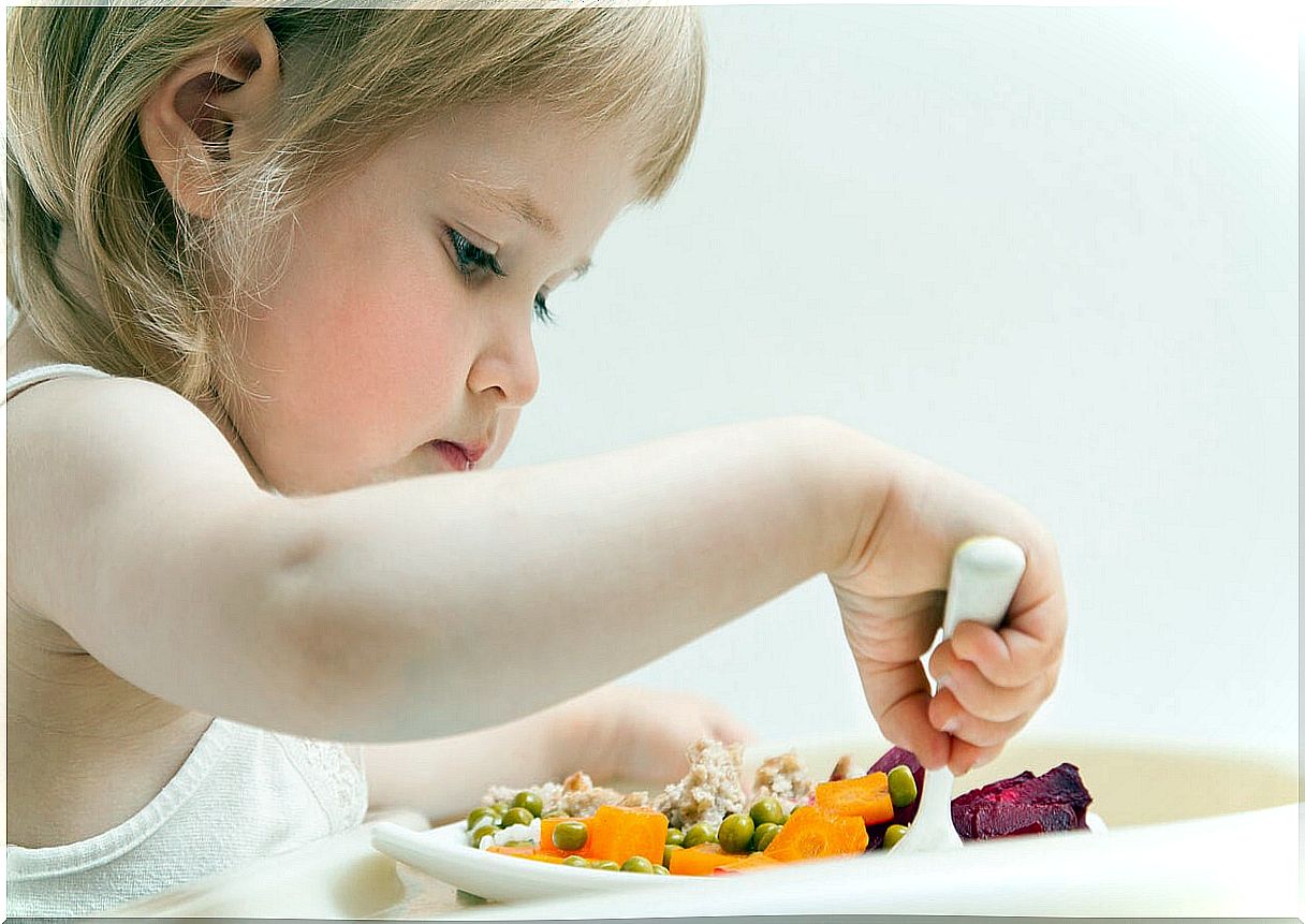 Little girl eating healthy to prevent eating disorders.