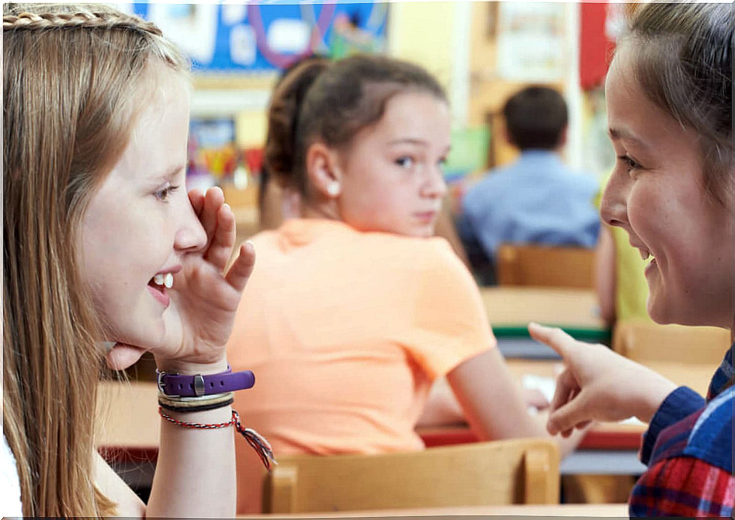 Girls laughing at a classmate who has been given a nickname.