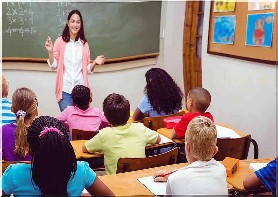 Teacher in class explaining to her students what self-assessment is for their education.