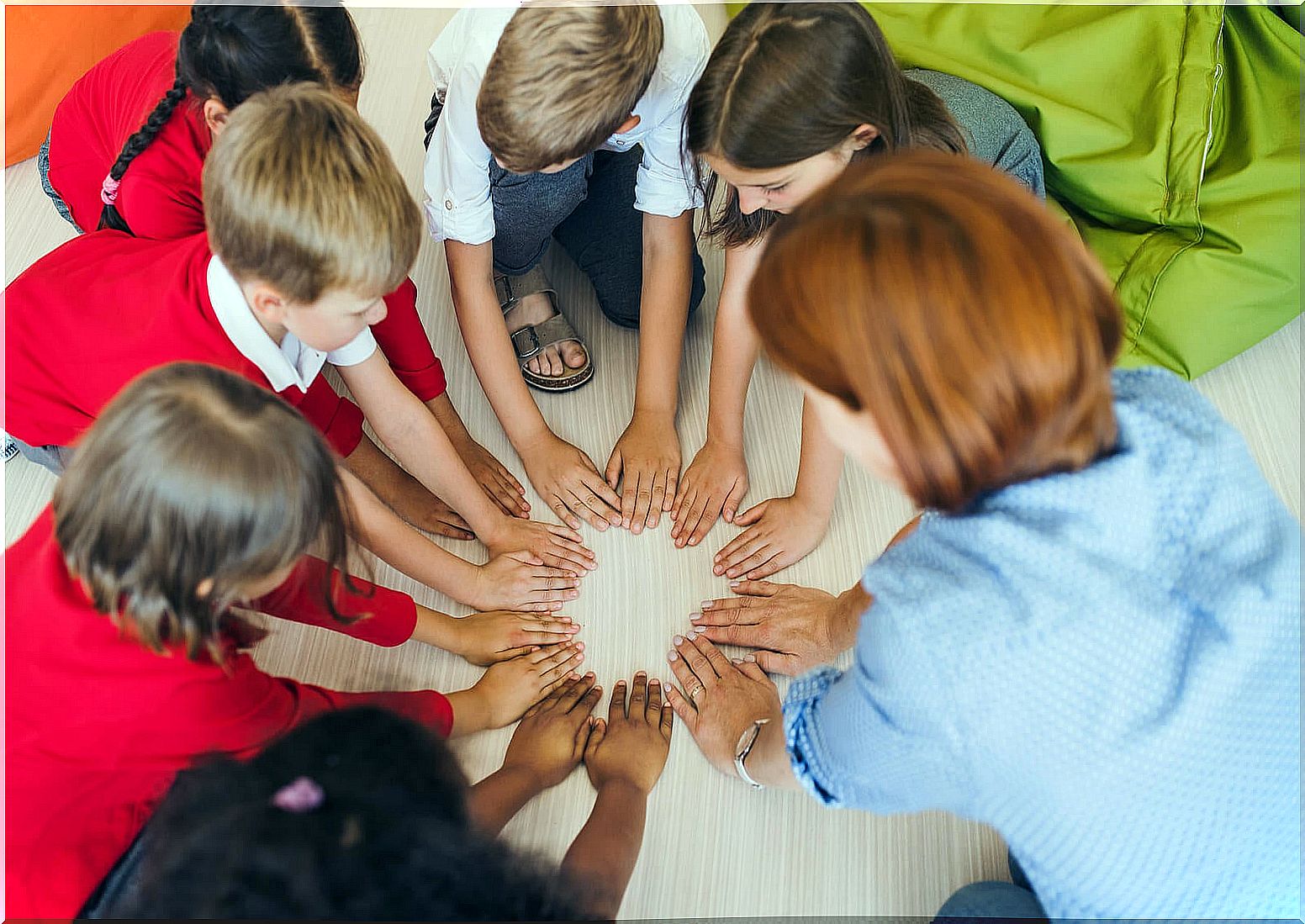 Teacher with her students doing the magic circle.