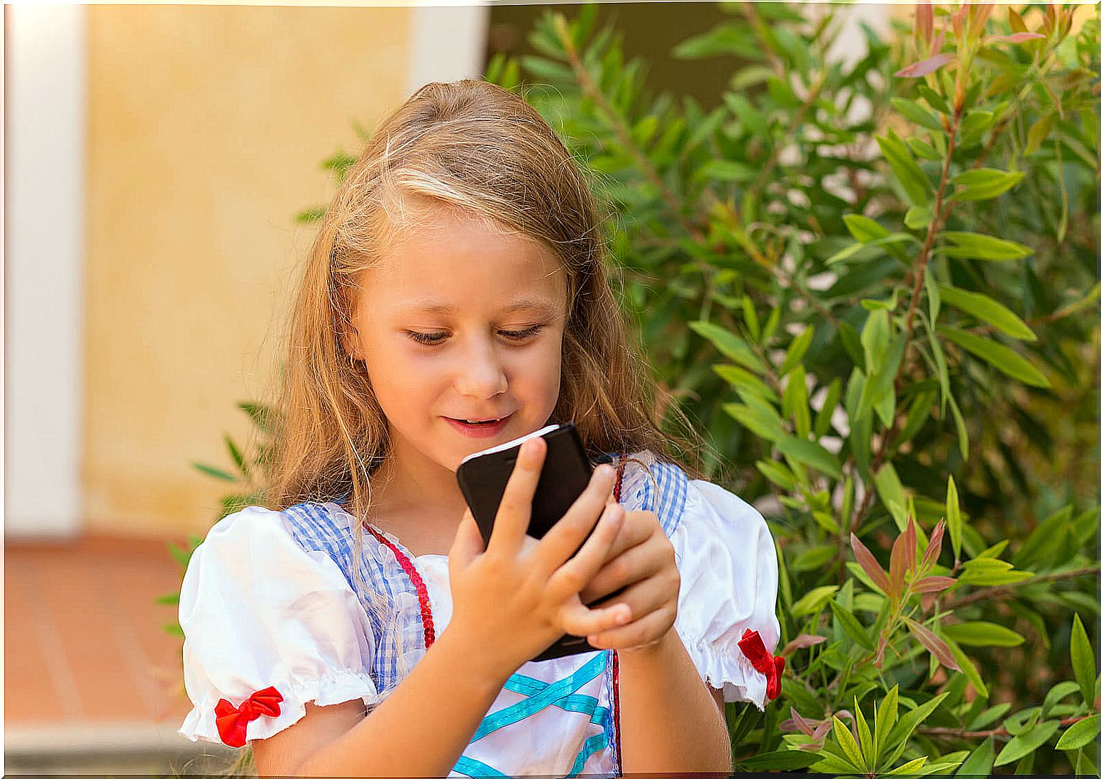 Girl sending message with mobile phone.