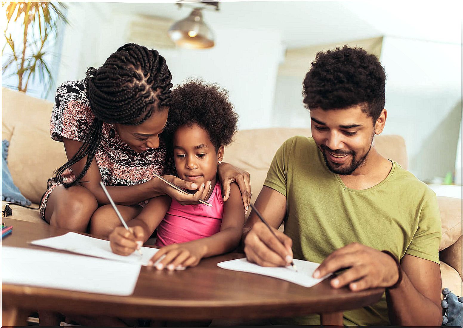 Parents supporting their daughter with her studies.