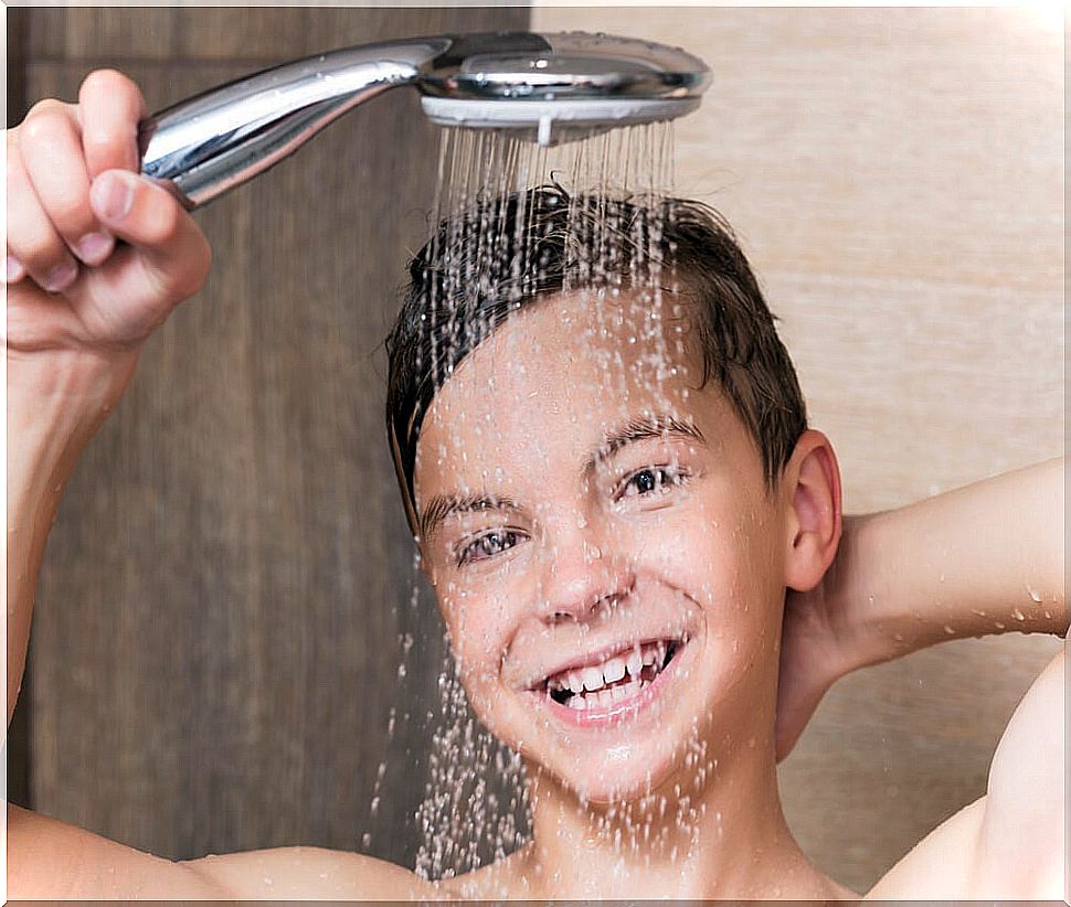 Teen boy taking a shower.